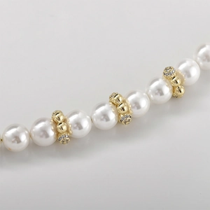 Macro shot of 14k gold-plated flower bead with cubic zirconia and pearls for DIY jewelry