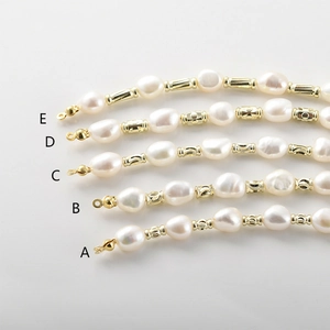 Detailed macro view of baroque pearl strands with diverse 14k gold-plated textured spacers