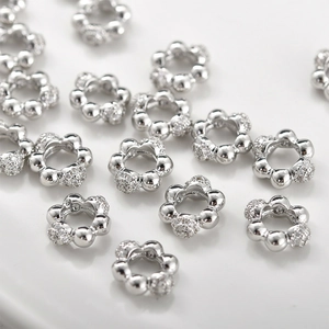 Macro shot of silver flower spacer beads with cubic zirconia for DIY jewelry making