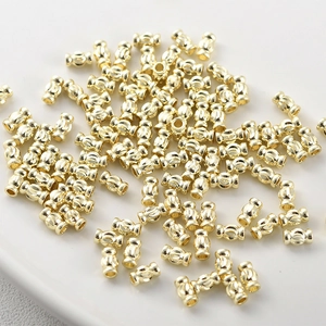 Macro view of 14k gold-plated textured column beads for DIY jewelry making