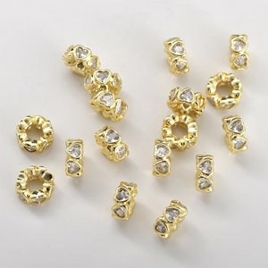 Detailed view of 14k gold-plated heart-shaped spacer beads with cubic zirconia for jewelry