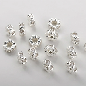 Close-up of heart-shaped spacer beads with cubic zirconia for DIY jewelry making