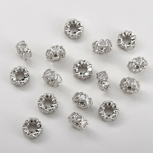 Macro view of heart-shaped hollow charms with sparkling cubic zirconia for DIY jewelry