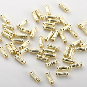 Macro shot of 14k gold plated textured cylinder tube beads for DIY jewelry making