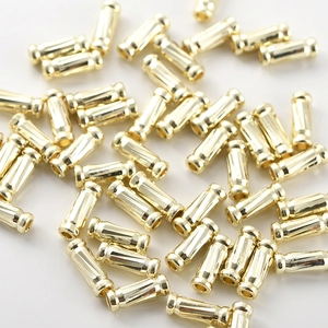 Close-up of 14k gold plated textured tube beads for DIY jewelry making and beadwork