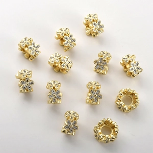 Detailed close-up of 14k gold plated double-layer flower beads with sparkling zircon inlay