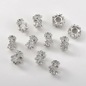 Macro detail of 14k gold plated flower spacer beads with sparkling zircon stones