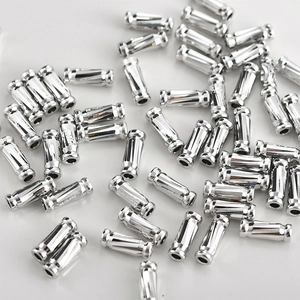 Macro shot of silver plated twisted tube beads for DIY jewelry and necklaces