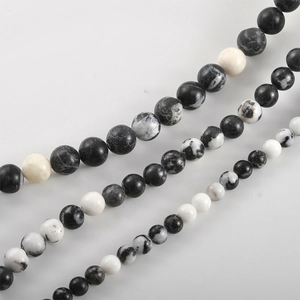 Detailed view of polished zebra stone round beads in three sizes for DIY jewelry making