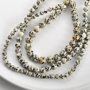 Macro shot of assorted size Dalmatian Jasper round beads for DIY jewelry making
