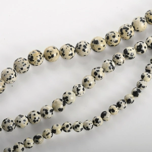 Macro shot of natural Dalmatian Jasper round beads for handmade jewelry making