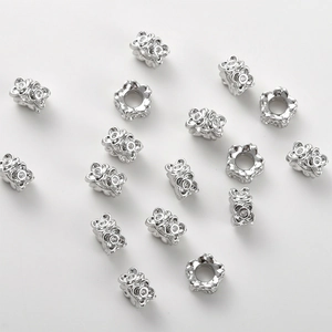 Detail of silver clover wheel beads with clear zircon pavé for DIY jewelry making