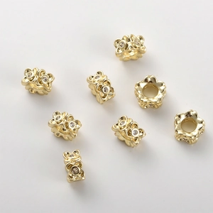 Detailed view of 14k gold plated clover spacer beads with sparkling zircon inlay for DIY