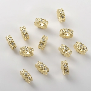 Close-up of 14k gold plated spacer beads with micro-set floral cubic zirconia details