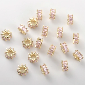 Detailed view of 14k gold-plated flower beads with pink baguette cubic zirconia