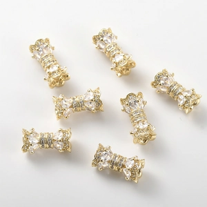 Detailed view of 14k gold-plated bow-shaped connectors set with sparkling pink zircon