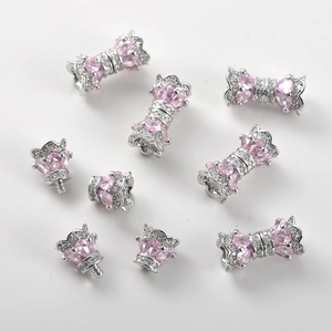 Detail of pink zircon bow connectors and silver screw clasps for DIY jewelry making