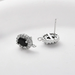 Macro shot of oval black gem stud earring with silver metal base and DIY hanging loop