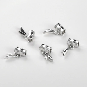 Detailed view of five silver bamboo-shaped metal tube charms with delicate leaf pendants