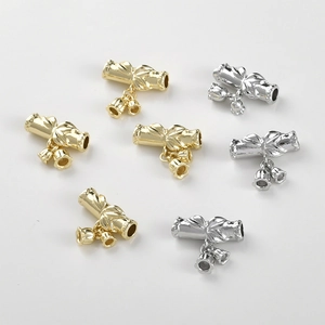 Close-up of 14k gold and silver plated bamboo lily of the valley pendants for DIY jewelry