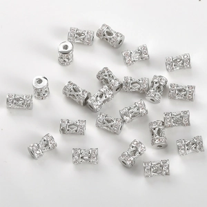 Macro shot of silver plated cylinder spacer beads with pavé set cubic zirconia stones