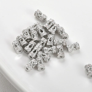 Macro shot of silver plated cylinder spacer beads with pavé set sparkling zircon stones