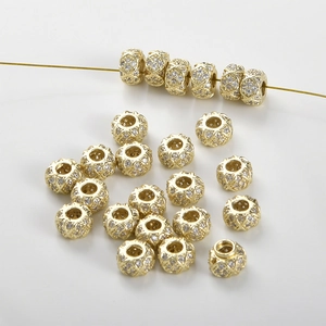 Detail of 14k gold plated wheel spacer beads with micro-paved cubic zirconia gems