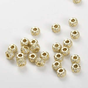 Close-up of 14k gold plated wheel spacer beads with micro-set zircon for DIY jewelry