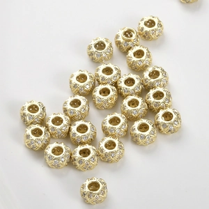 Macro shot of 14k gold plated wheel bead with micro-pave cubic zirconia for DIY jewelry