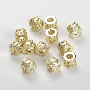 Macro detail of 14k gold plated hexagonal wheel spacer beads with double row cubic zirconia