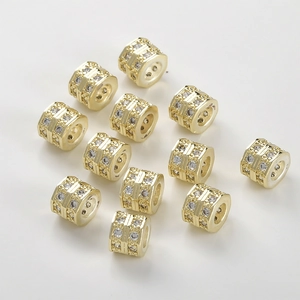Macro view of gold-plated wheel beads with micro-pave cubic zirconia for DIY jewelry