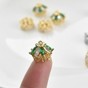 Dettaglio del ciondolo a corona placcato oro 14k con zirconi marquise verdi e bianchi
