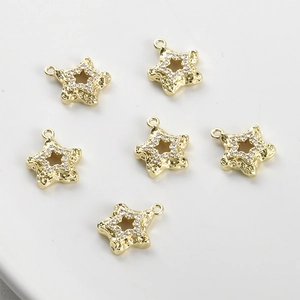 Macro detail of 14k gold-plated star pendants with hammered texture and cubic zirconia