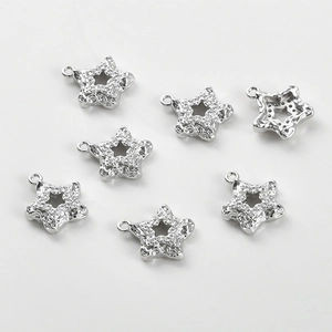 Macro shot of 14k silver plated star pendants with micro-paved cubic zirconia crystals