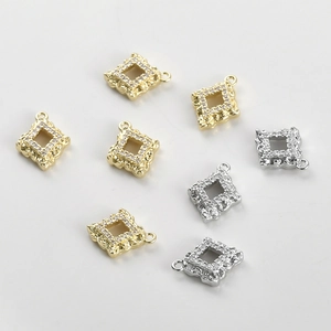 Detailed view of 14k gold-plated square openwork charms with engraved patterns and zircons