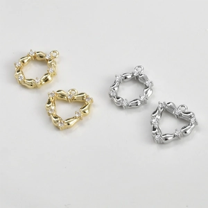 Detailed view of 14k gold plated heart and round charms with zircon stones for DIY jewelry