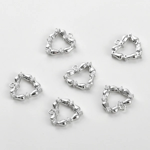 Detailed view of six heart-shaped bamboo style silver pendants with cubic zirconia