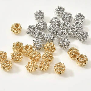 Macro detail of 14k gold and silver braided bead spacers for DIY jewelry making