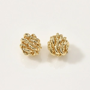 Close-up of 14k gold plated twisted wire weave ball stud earrings with polished texture