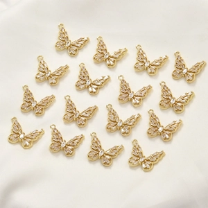 Close-up of 14k gold-plated hollow butterfly pendants with marquise zircon stones