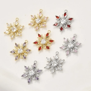 Detailed view of 14k gold-plated snowflake charms with colorful zircon stone settings