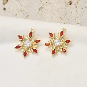 Macro shot of 14k gold plated snowflake pendants with red marquise stones and zircon