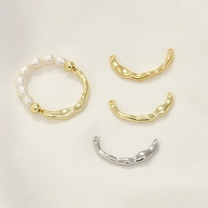 Macro detail of 14k gold plated textured metal parts and pearls for DIY ring jewelry making