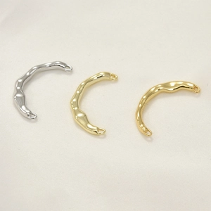 Close-up of textured 14k gold plated irregular open ring components in three metal tones