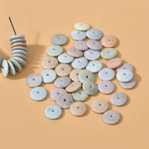 Detailed macro view of colorful flat round natural stone beads for DIY jewelry making