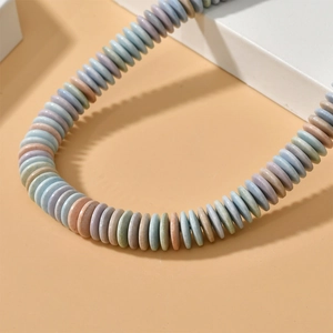 Macro detail of matte rainbow stone disc beads for DIY jewelry in macaron colors