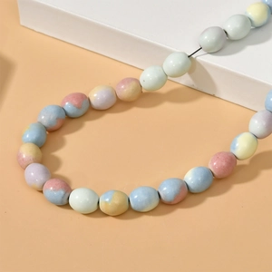 Detail of colorful rainbow stone pumpkin beads with macaron marble texture for DIY jewelry