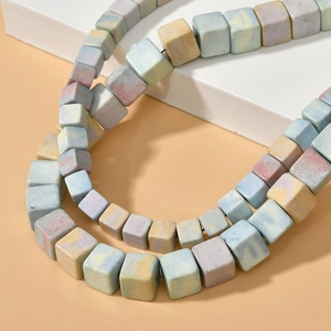 Macro shot of cubic rainbow stone beads with pastel marble texture for DIY jewelry