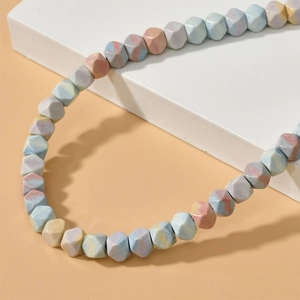 Detailed view of faceted rainbow stone beads with natural marble texture for DIY jewelry