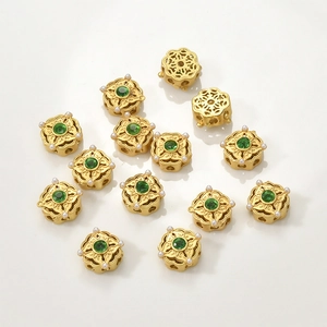 Detail of vintage gold-plated spacer beads with green stones and mini pearls for DIY